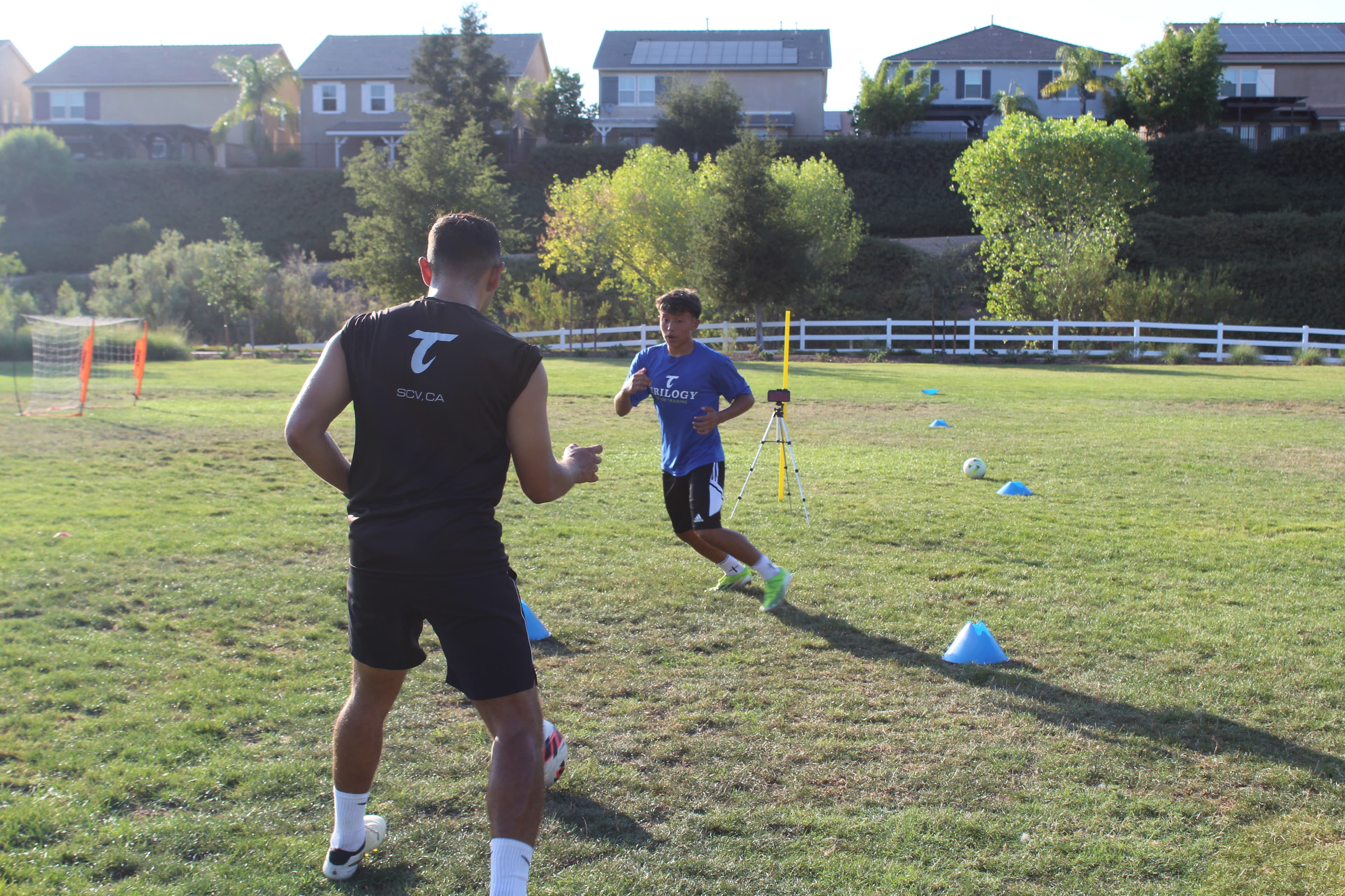 Trilogy Soccer coach guiding a player through field training