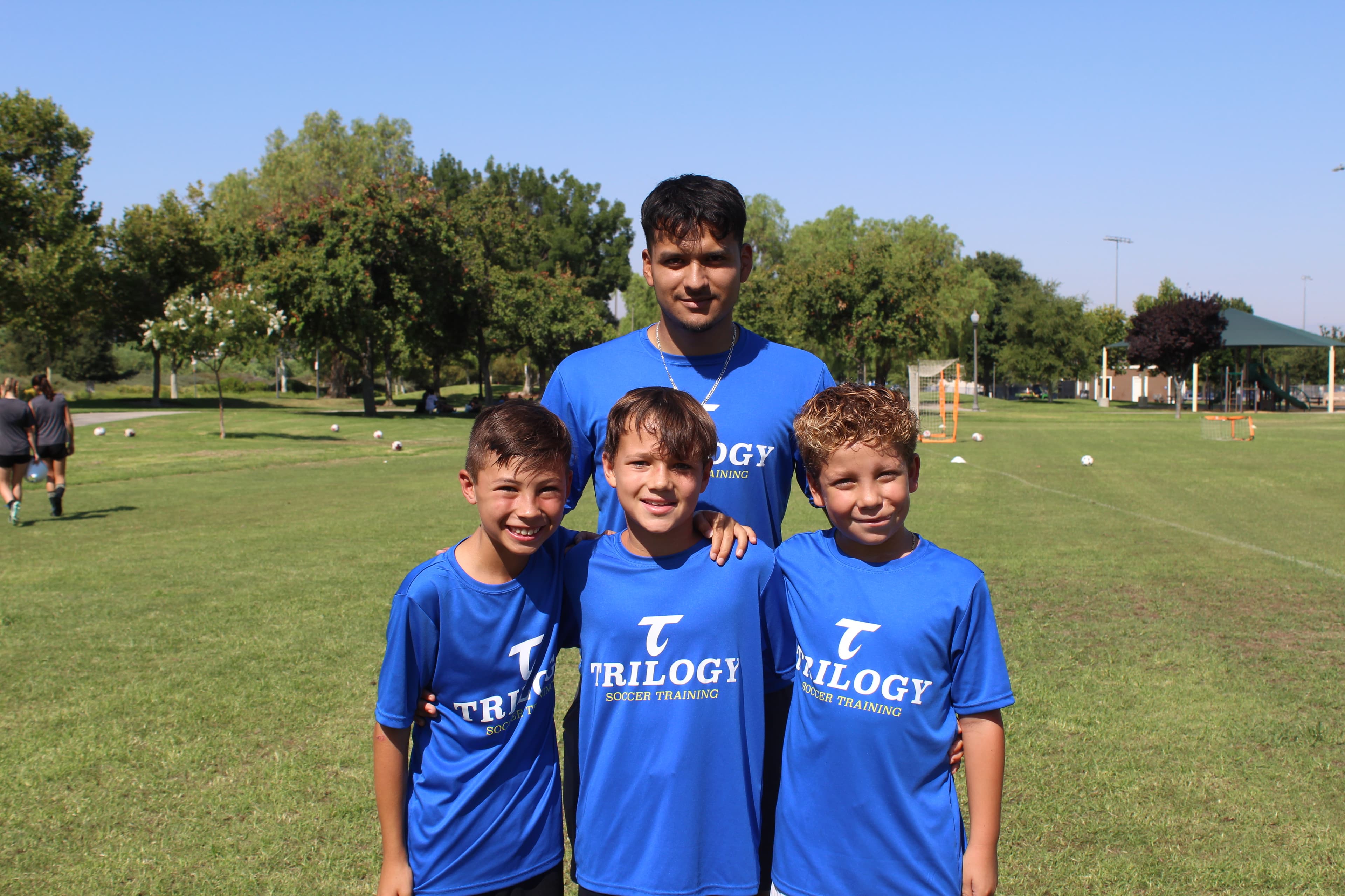 Trilogy Soccer coach with young players after training